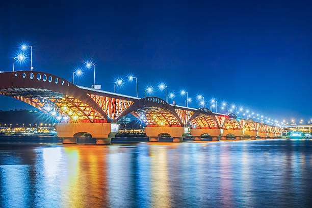 A night view of the bridge with splendid lights over the gently flowing Han River