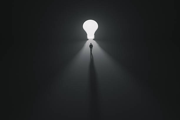 istock Business man walking toward a bright light bulb door, inspiration, creativity, innovation, and the search for new idea. Concept of bright ideas, imagination, and the power of human thought. 2241469947