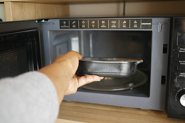 istock Heating a meal in the microwave at home kitchen 2241470510