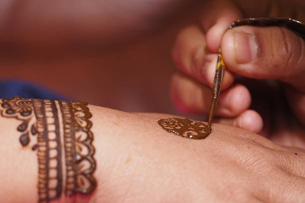 istock Applying intricate henna designs on a hand in celebration 2241471526