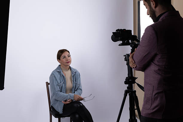 istock A photographer conducts a photojournalistic interview with a subject in a studio setting 2241476726