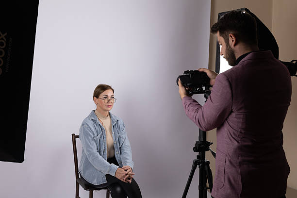 istock A photographer conducts a photojournalistic interview with a subject in a studio 2241477052
