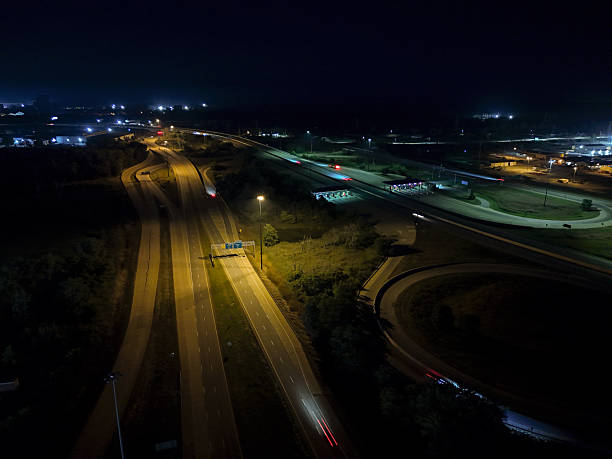 istock Cars speeding down highway at night, tracing light trails 2241477096