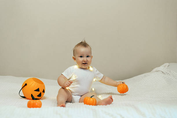 istock Baby Playing with Pumpkins on Halloween 2241477099