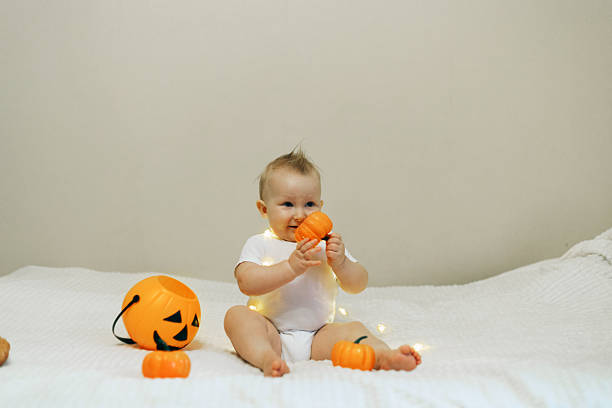 istock Baby Playing with Pumpkins on Halloween 2241477110
