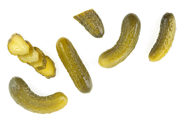 istock Delicious marinated pickled cucumbers and slices isolated on a white background, top view. 2241478810