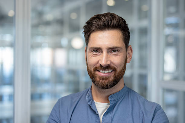 istock Smiling bearded man in modern office environment with positive and professional demeanor 2241483183