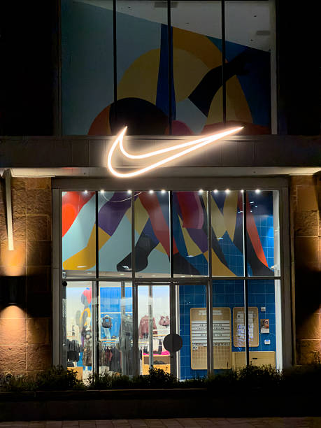 Boulder, Colorado, USA - October 11, 2025: Nike store displaying a colorful abstract art facade and illuminated logo at night