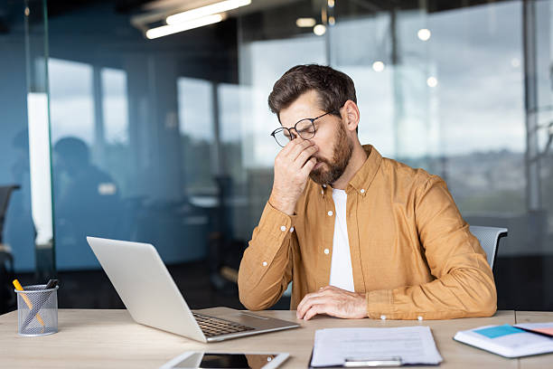 istock Businessman experiencing stress and headache from work burnout 2241484784
