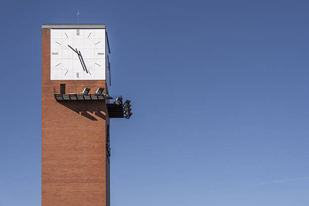 istock Brick tower with a large clock and spotlight supports 2241485297