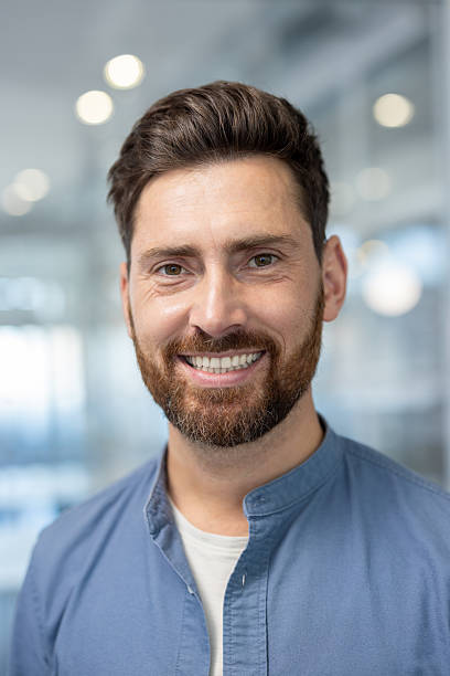 istock Smiling man poses confidently in a professional office environment 2241487753