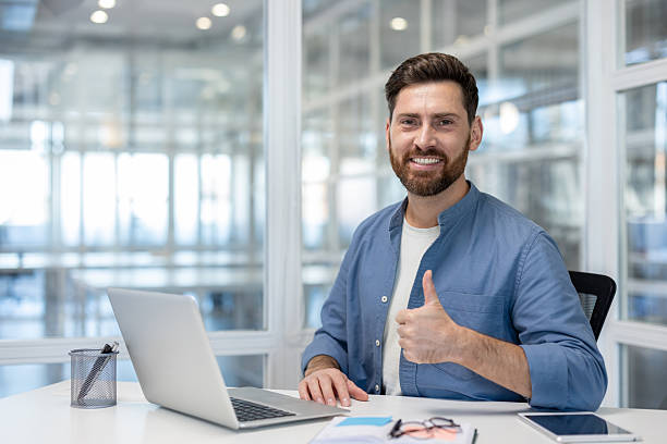 istock Happy man in office giving thumbs up 2241487835
