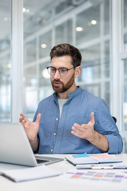 istock A businessman in a video conference, discussing a project from his office. 2241488786