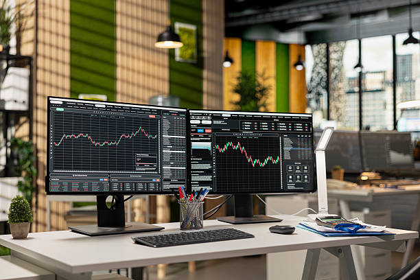 istock Computer monitors in forex company office displaying stock exchange price charts 2241491510