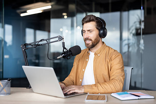 istock Male podcaster broadcasting online from a modern office 2241491714