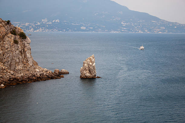 A serene coastal view with rugged cliffs overlooking the calm blue sea.