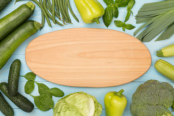 istock Different fresh green vegetables on wooden background, top view 2241497124