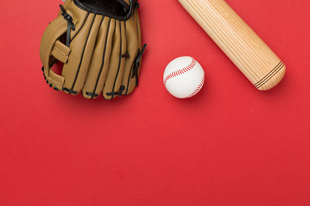 The baseball field features baseball equipment, including baskets filled with baseballs and bats.