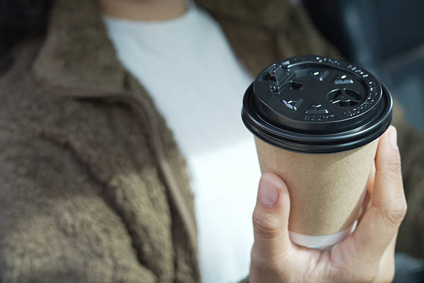 istock Man is drinking hot coffee in the car before going to work at the office every time. 2241497811