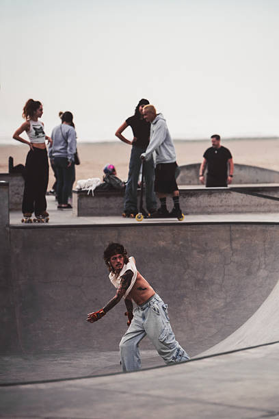 Venice Beach, CA - December 22, 2024 -  Color image capturing candid, dynamic action of a guy doing tricks on rollerblades on the ramp of at the iconic Venice Beach Skatepark
