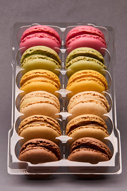 istock Colorful macarons stacked in transparent plastic box 2241503410