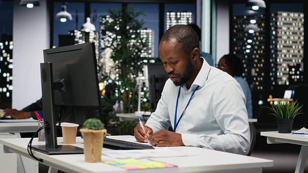 istock African american employee writing growth strategy notes on a textbook 2241503701