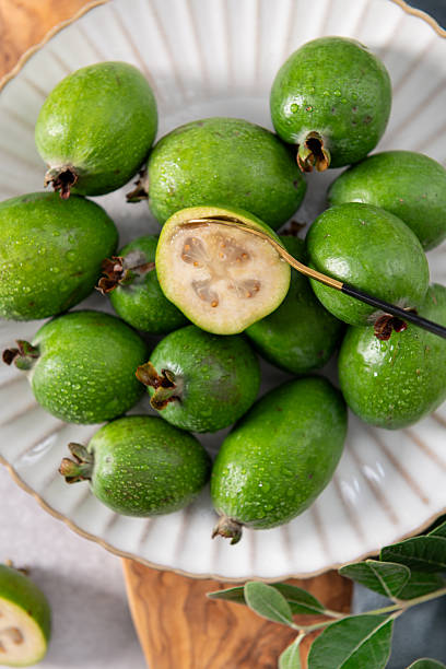 istock Close-up of a spoon in a half feijoa fruit 2241505521