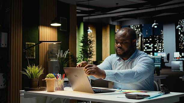 istock African american office worker placing a sticky note on his laptop as a reminder 2241510761