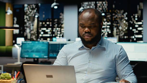 istock Male company analyst reading data reports and fact checking on laptop 2241512575