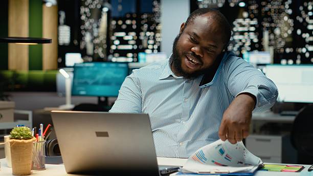 istock Male employee calling partner on phone for a remote chat late at night 2241515418