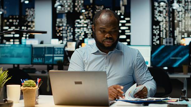 istock Black business consultant working after hours fact checking web information 2241515501