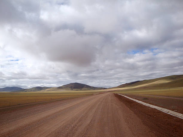 istock Vast open road under cloudy sky in a rural area 2241515843