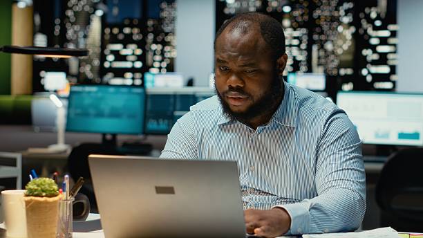 istock African american guy at the workspace sitting in deep concentration 2241516546