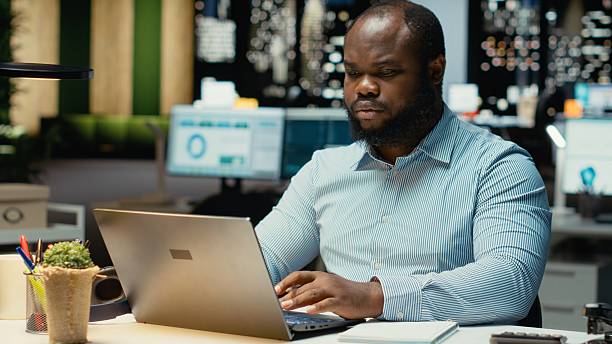 istock Male finance analyst after hours fact checking and transcribing documents 2241516639