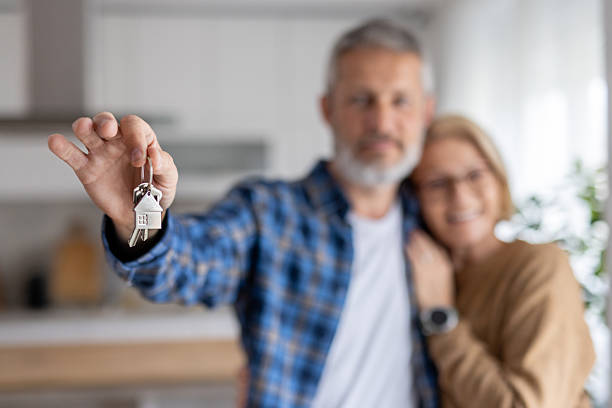 istock Couple celebrating with keys in a cheerful home environment. 2241519632