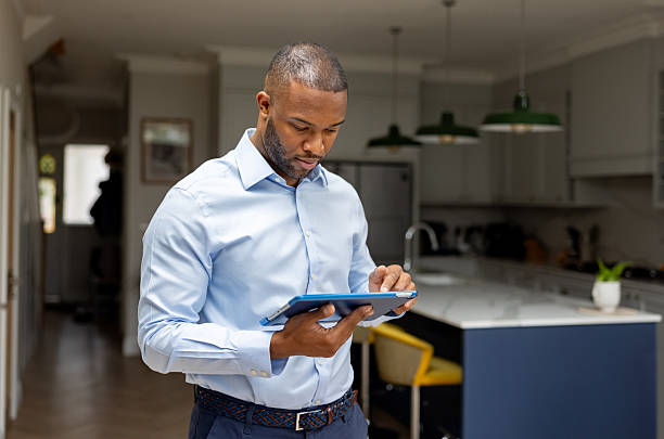 istock Real estate agent using a digital tablet at a house for sale 2241521422