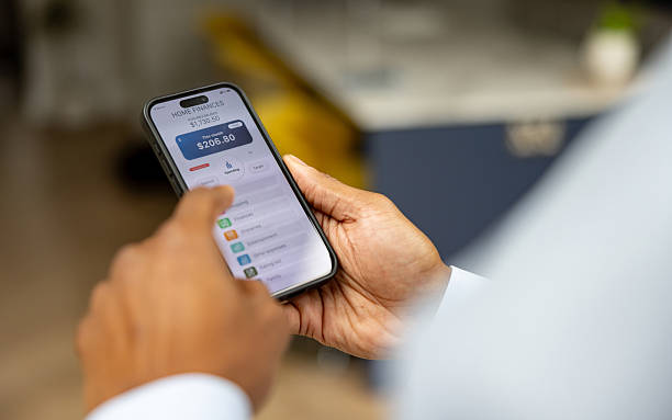 istock Man using a financial app on his cell phone 2241521456