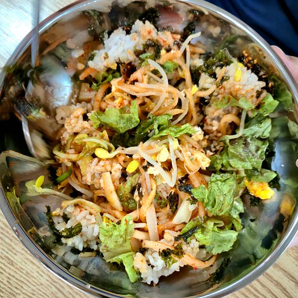 Korean bibimbap mixed in a metal bowl