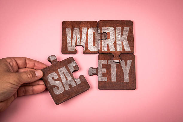 istock WORK SAFETY Concept. Wooden puzzle pieces with text on pink background 2241533346