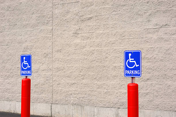 istock handicap sign in parking area against brick wall 2241534799