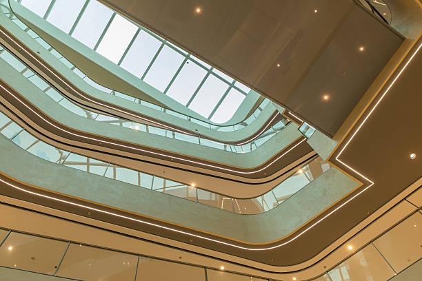 istock A low-angle view of a modern atrium with curved balconies and a skylight. 2241536810