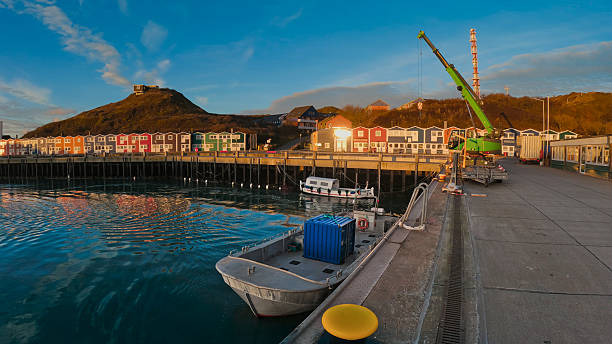 istock Maritime pier breaking waves next to pilings at sunset 2241539727