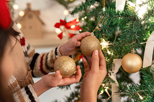 istock Christmas Decorations. Child and mother selecting ornaments for the tree. 2241543066