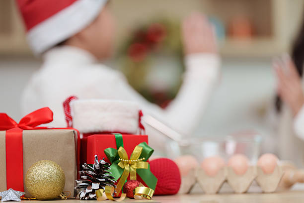 istock Christmas Celebration. Family bonding while decorating holiday cookies in festive kitchen. 2241543545
