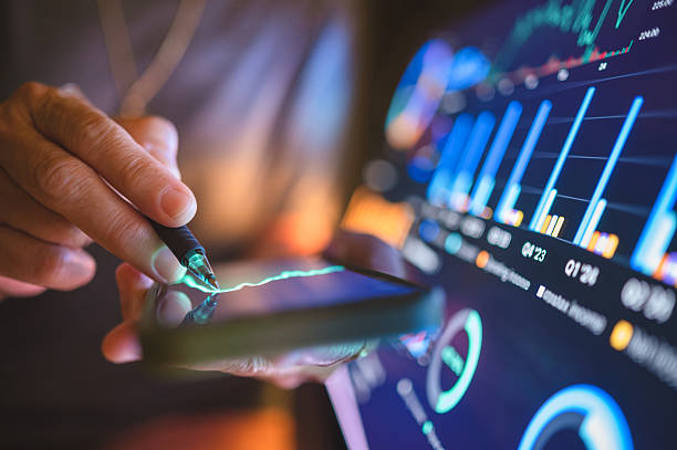 istock Macro shot of person interacting with AI-generated data on tablet, analyzing global investment and trading. Represents intelligent finance, innovation, and digital economy. 2241543627