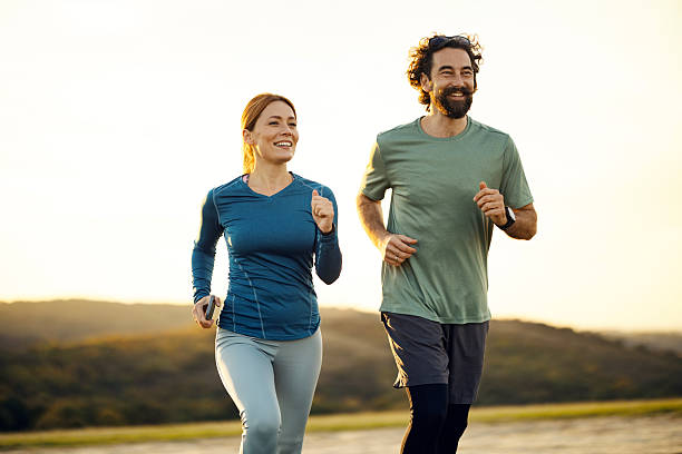 istock Couple jogging together outdoors during sunset 2241548499