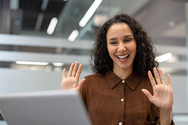 istock Woman making video call waving hands hello 2241550080