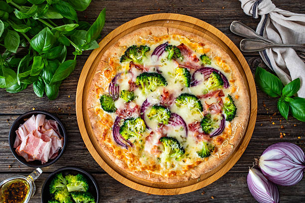 istock Circle pizza broccoli with bacon and mozzarella cheese on wooden background 2241550712