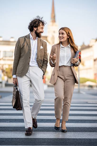 istock Businesspeople crossing the street while talking about work 2241550825