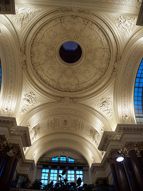 Grand Hall Dome Interior, Brussels Exchange - Low-angle view of the domed, ornate ceiling and columns inside the historic Bourse (Exchange) building in Brussels, Belgium.